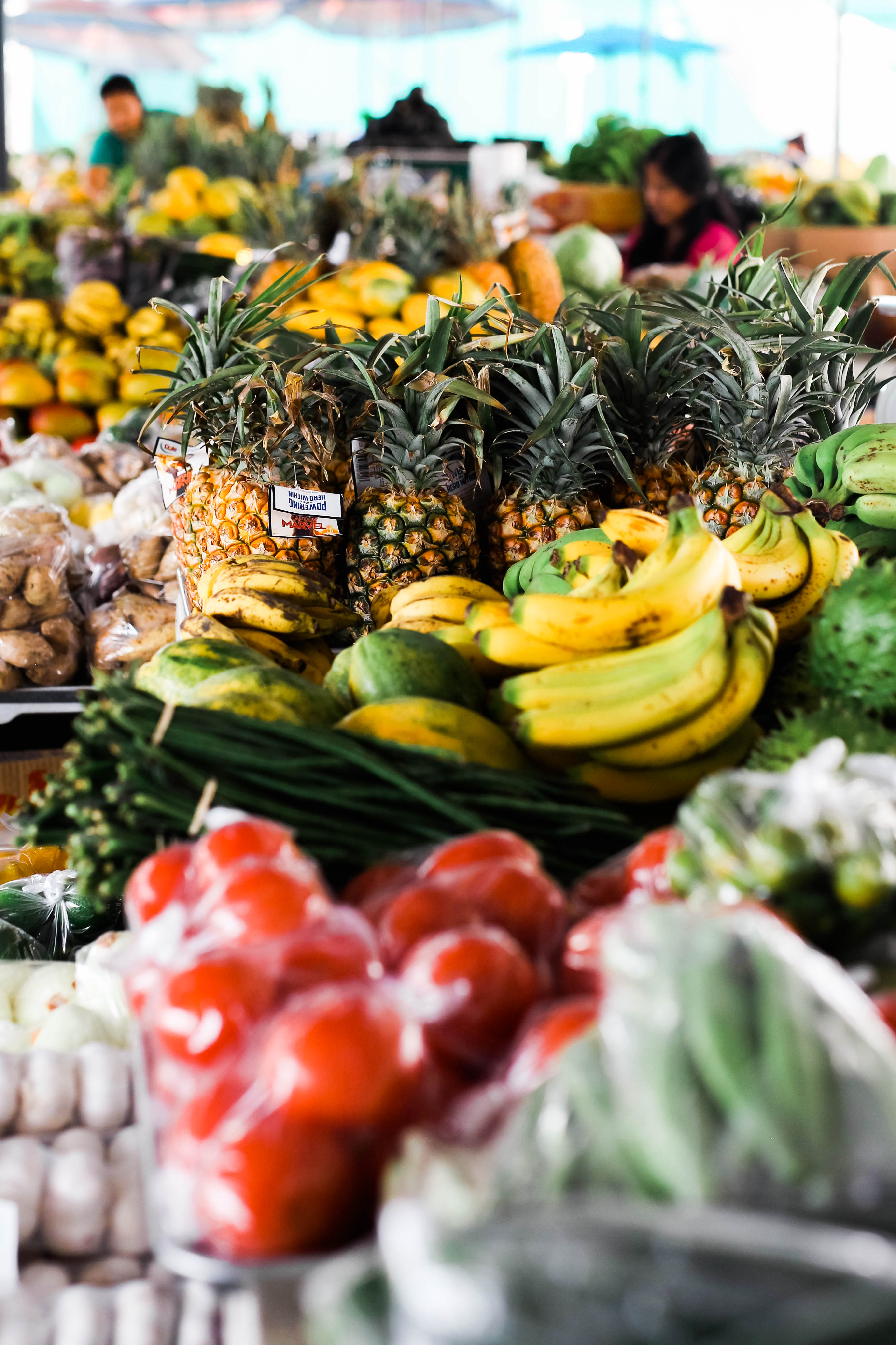 Fresh pineapples, bananas, and vegetables at a local market